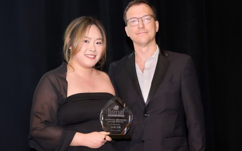 a man and woman holding a trophy