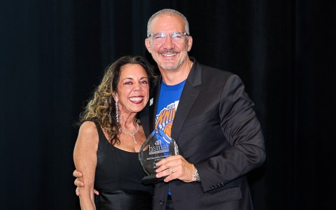 a man and woman holding a trophy
