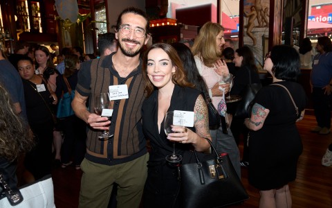 a man and woman holding wine glasses