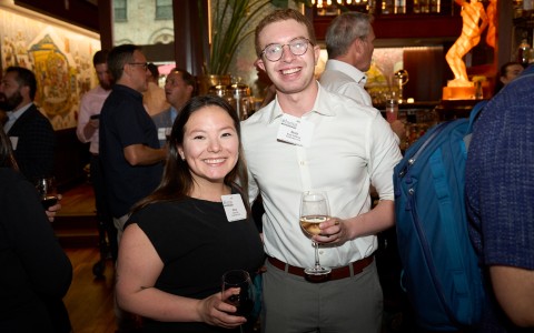 a man and woman holding wine glasses