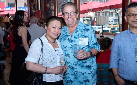 a man and woman holding wine glasses
