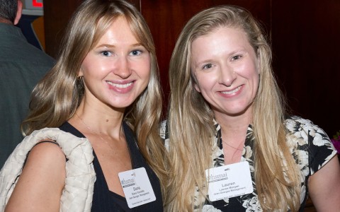 a couple of women smiling at camera