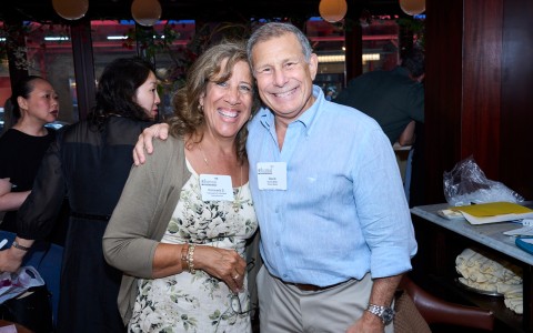 a man and woman smiling at a party