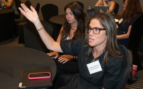 a woman raising her hand