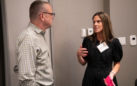 a man and woman talking in a room