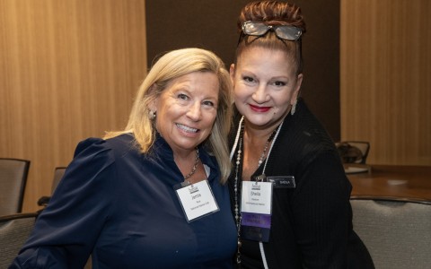 two women smiling at the camera