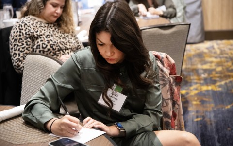 a woman writing on a paper