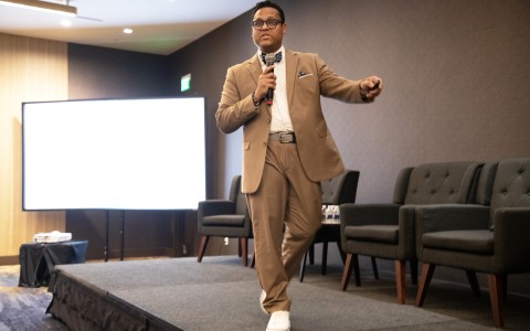 a man in a suit and tie on a stage
