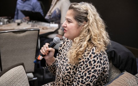 a woman sitting in a chair holding a microphone
