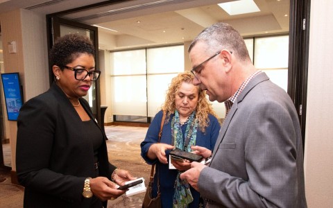 a group of people looking at a cellphone
