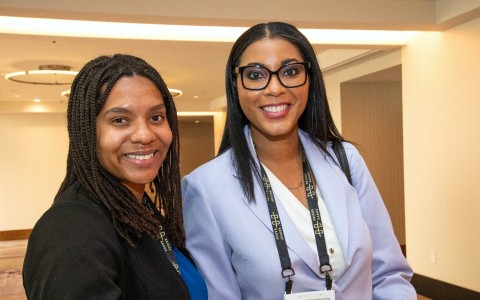 a couple of women smiling at the camera