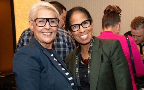 a couple of women smiling at the camera
