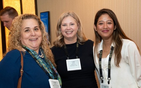 a group of women smiling at camera