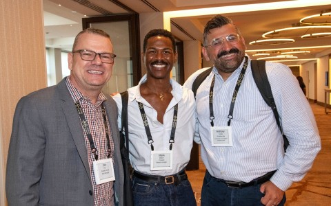 a group of men wearing lanyards and badges
