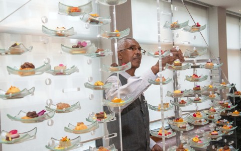 a man standing in front of a glass display