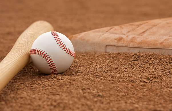 a baseball and bat on dirt
