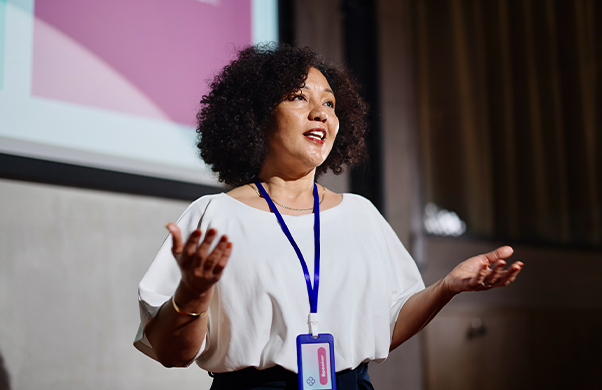 a woman standing in front of a screen