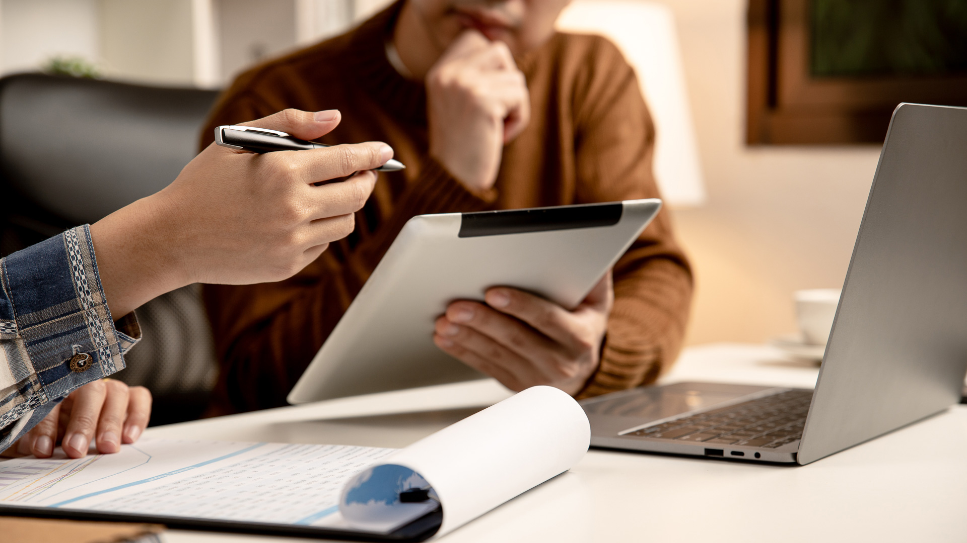 a person holding a tablet and pen