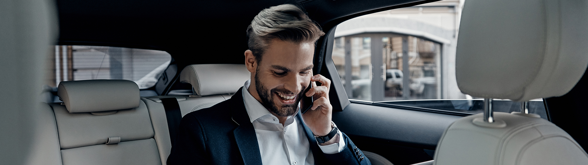 a man in a suit talking on a cell phone