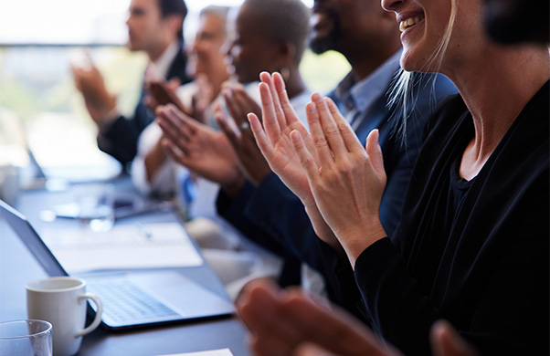 a group of people clapping hands