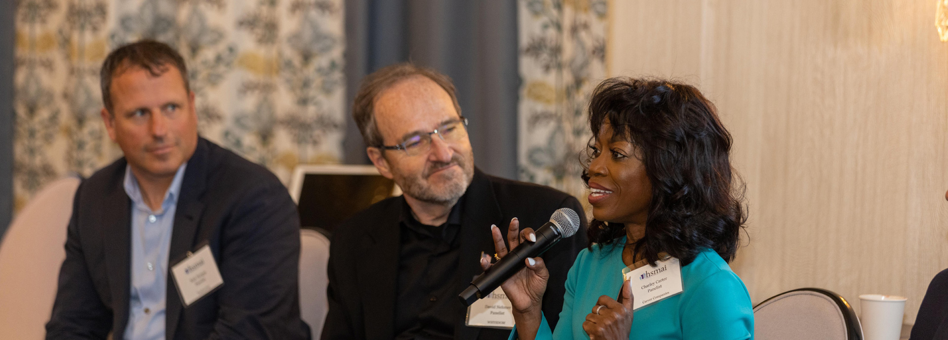 a man and woman talking into a microphone