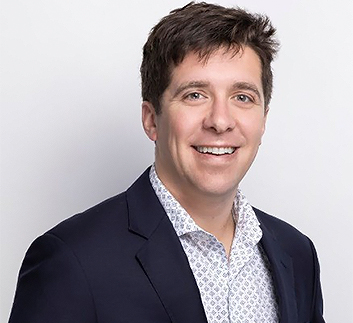 a man in a suit smiling