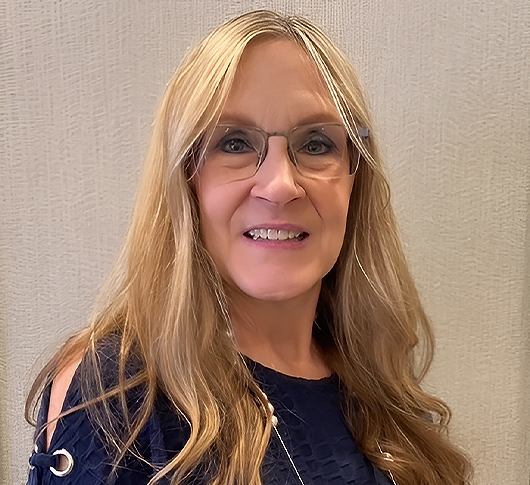a woman with long blonde hair wearing glasses
