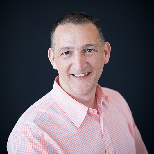 a man smiling at the camera