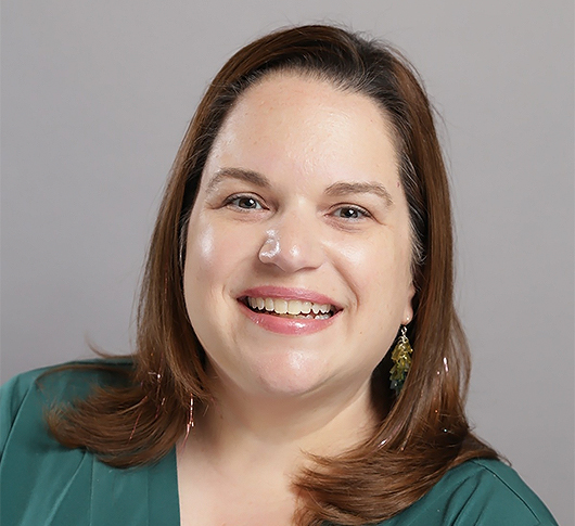 a woman smiling with a white substance on her face