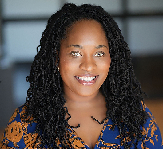 a woman with curly hair smiling