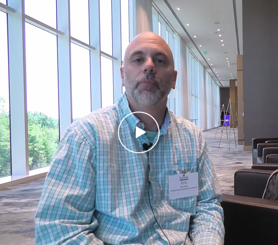 a man sitting in a room with windows