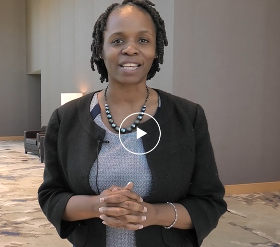 a woman smiling with her hands together
