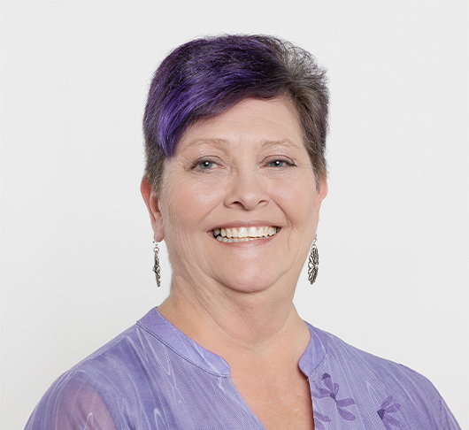 a woman with purple hair smiling