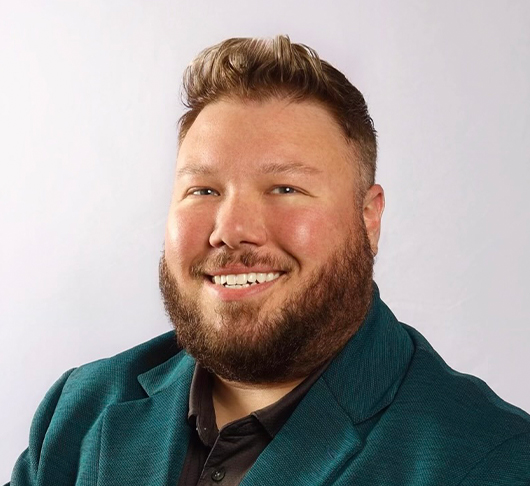 a man with a beard smiling