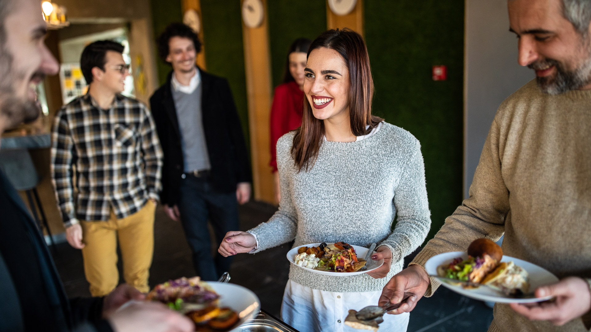a woman holding a plate of food