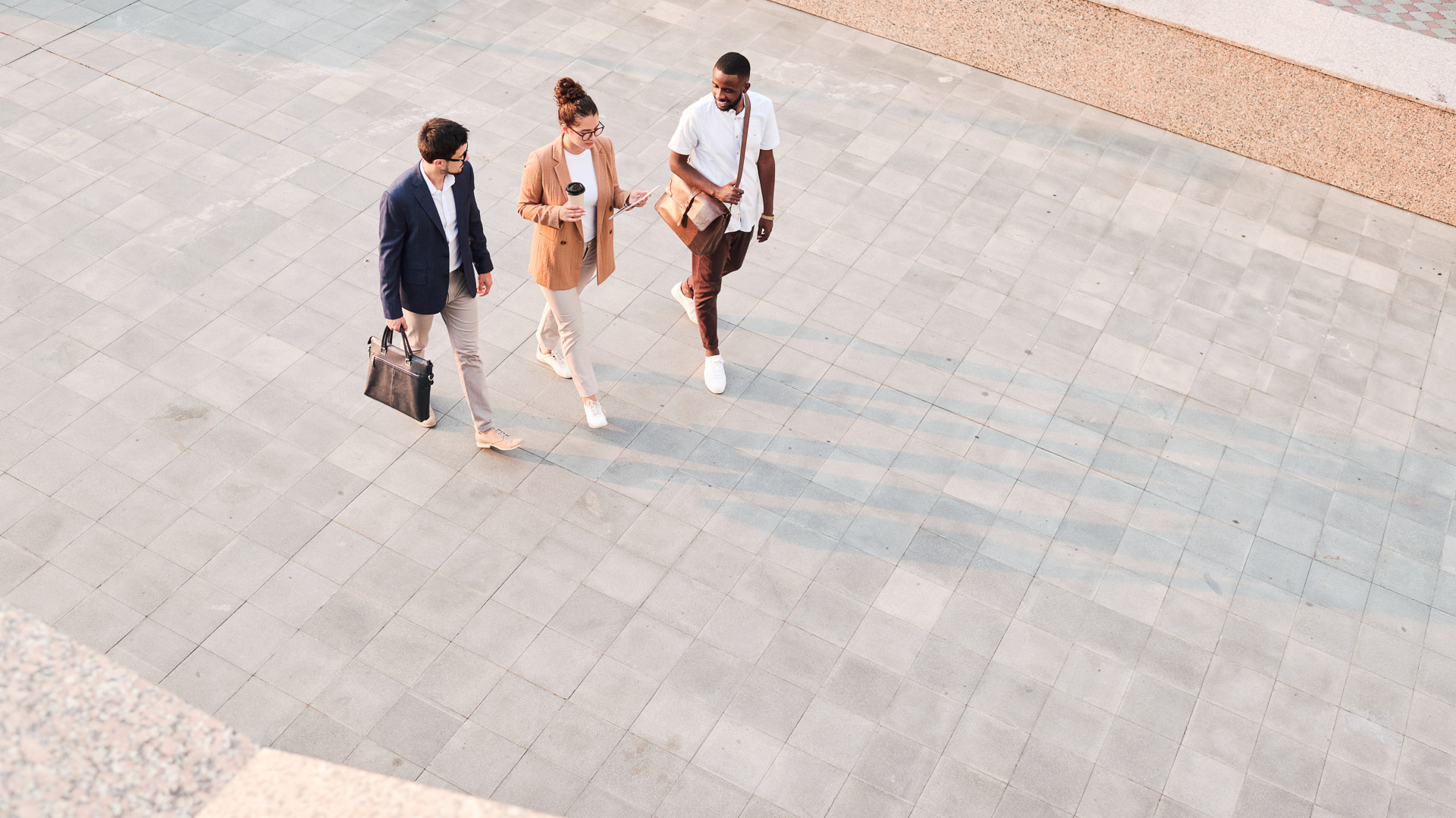 a group of people walking on a sidewalk