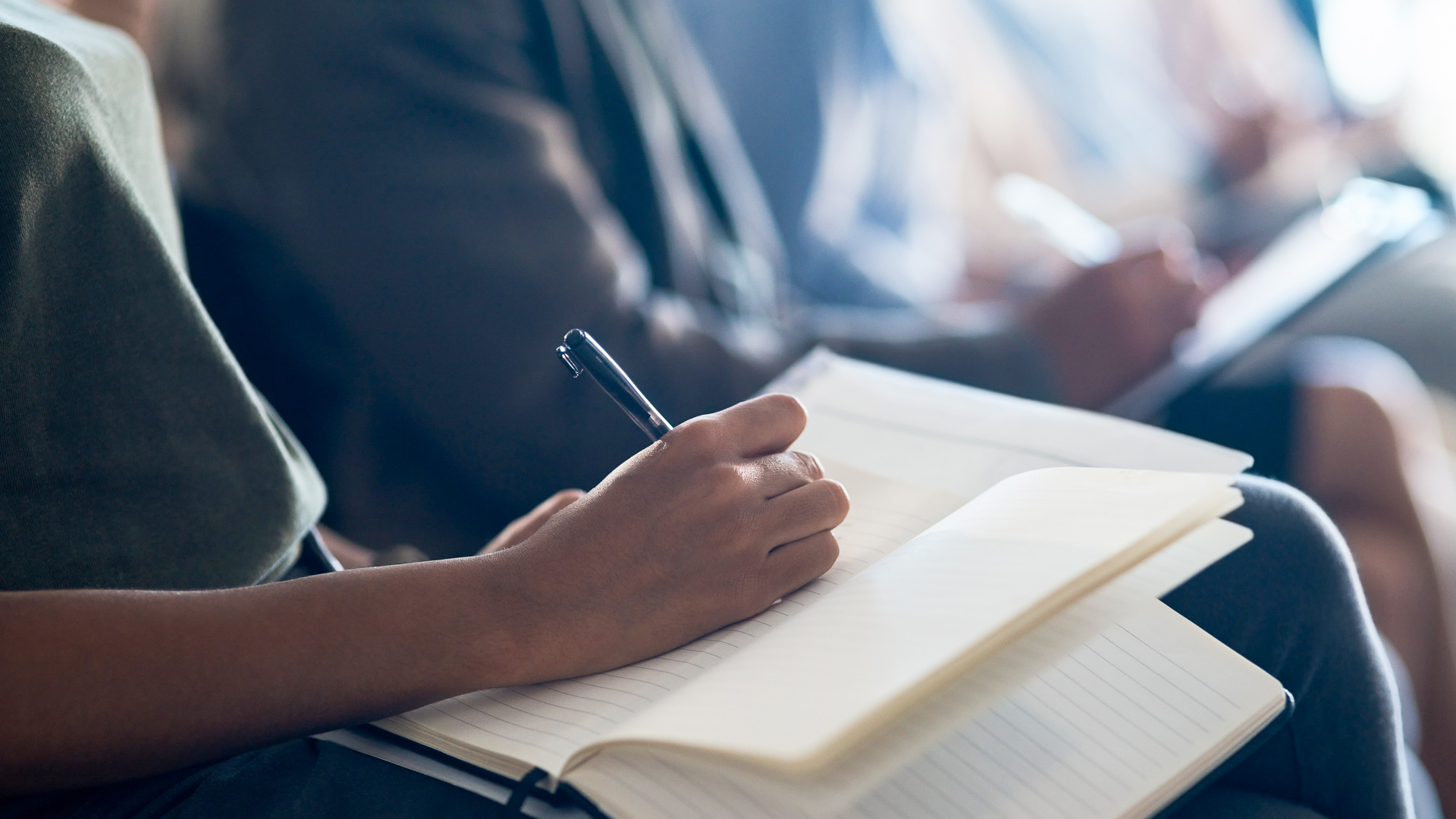 a person writing in a notebook