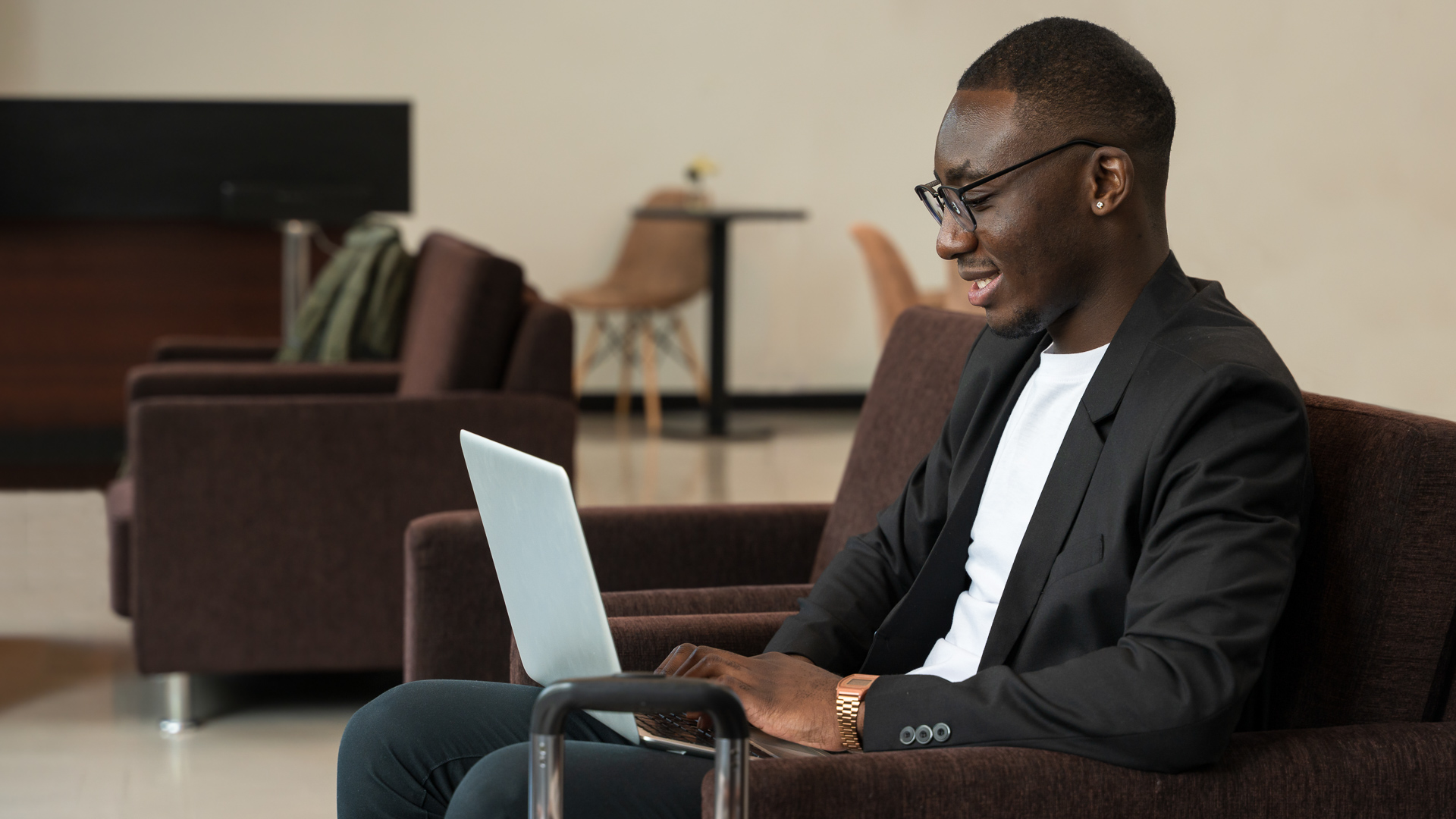 a man sitting in a chair with a laptop