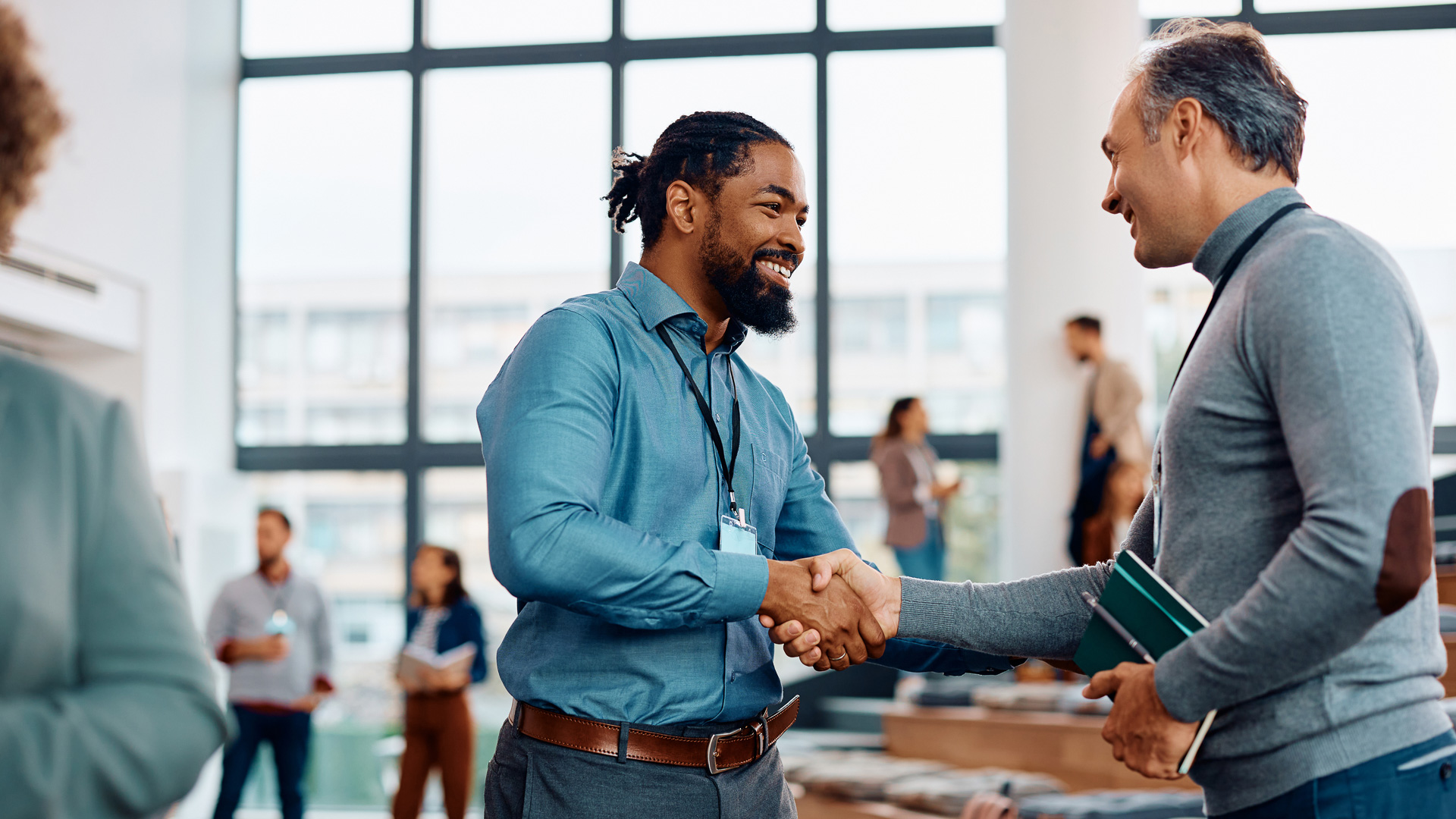 a man shaking hands with another man