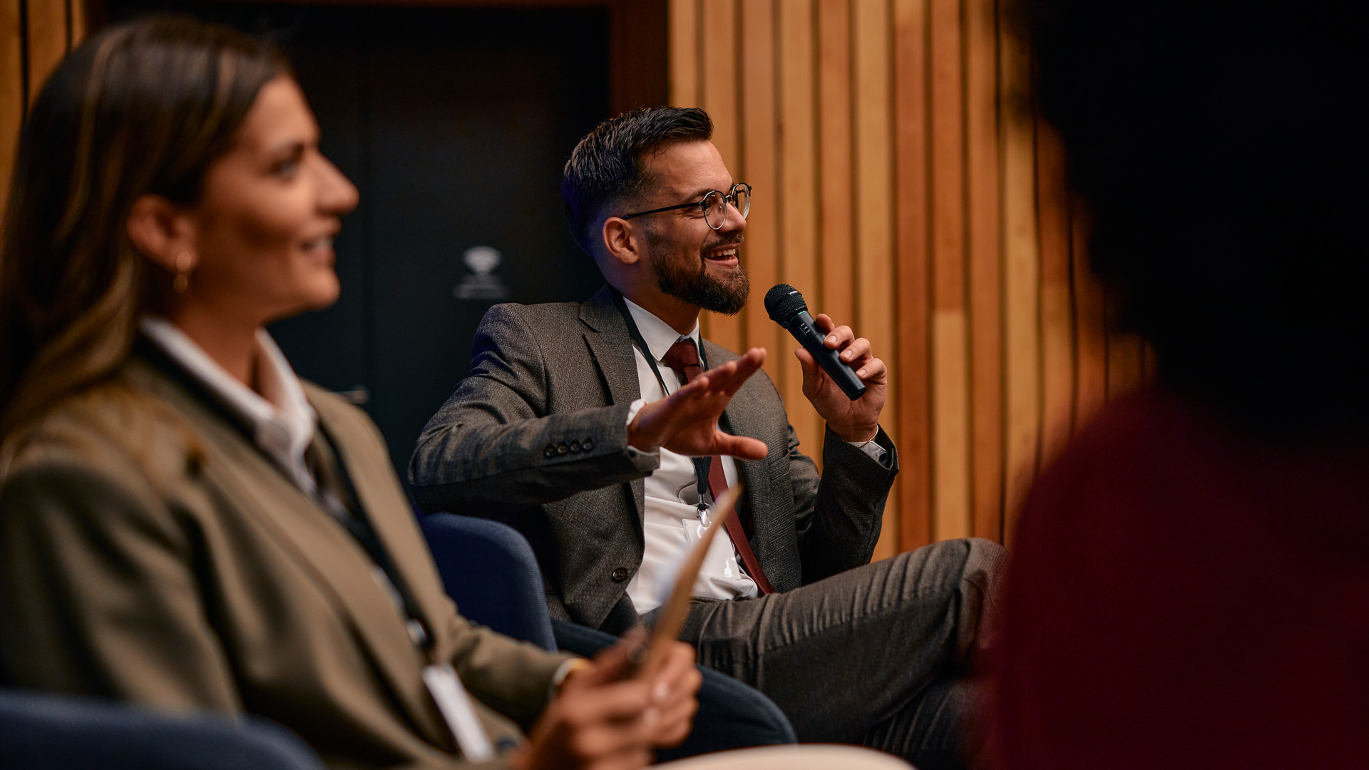 a man in a suit holding a microphone