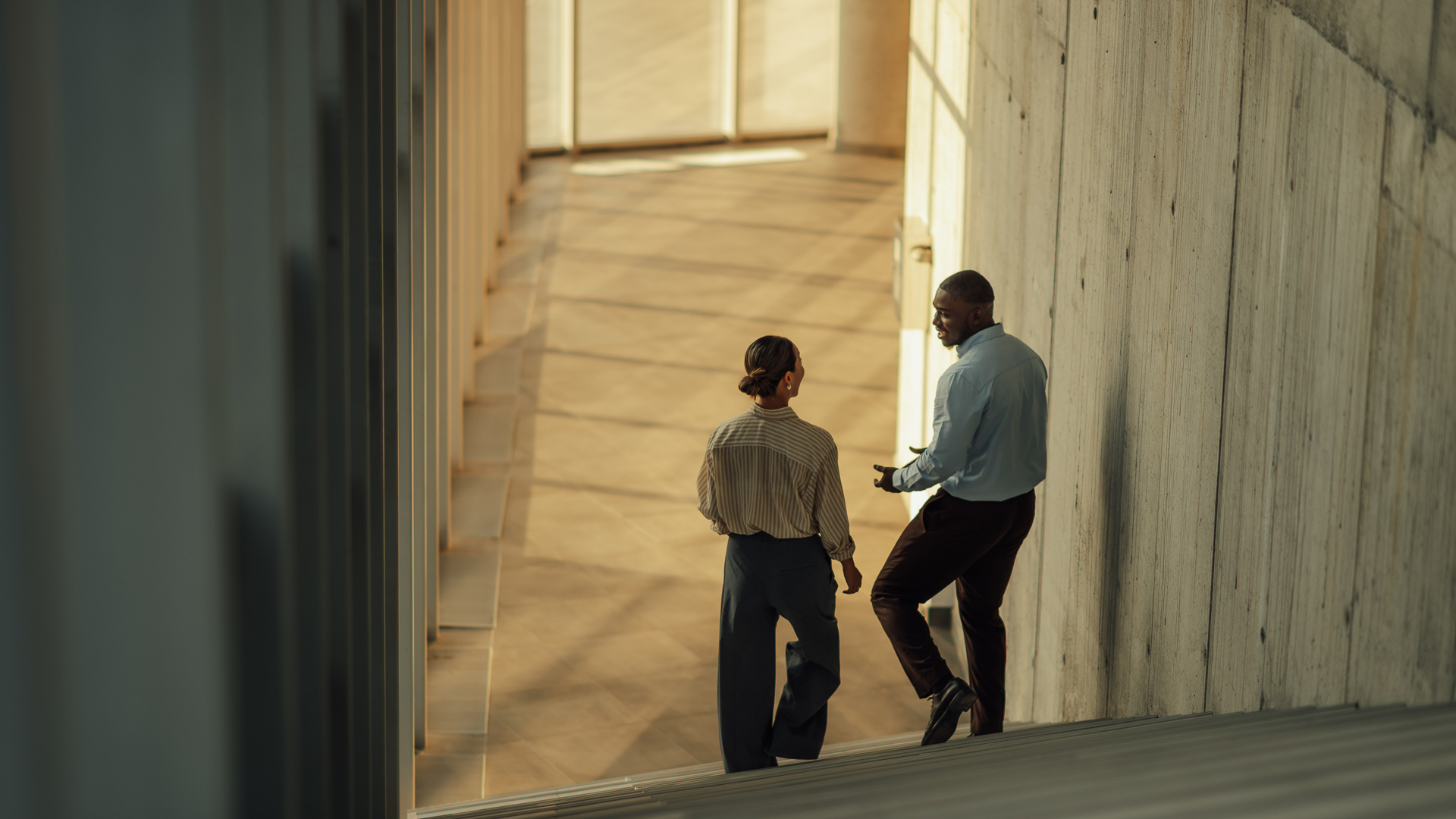 a man and woman standing on stairs