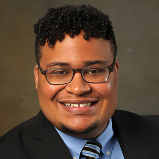 a man wearing glasses and a suit