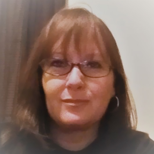 a woman wearing glasses and a black shirt