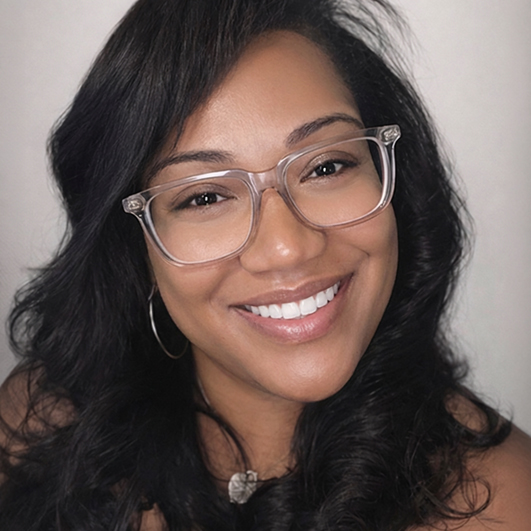 a woman with long hair wearing glasses