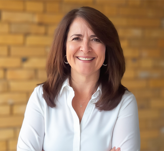 a woman smiling with arms crossed