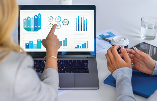 a person pointing at a laptop screen