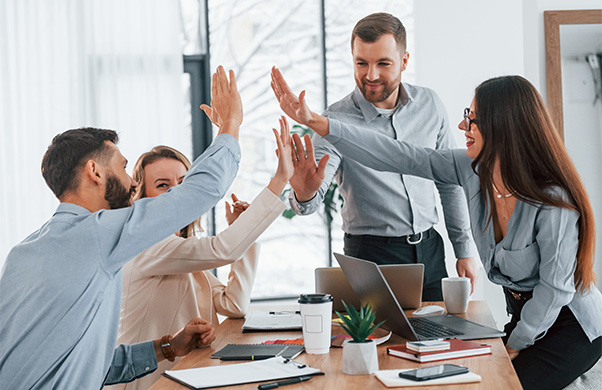 a group of people giving each other a high five