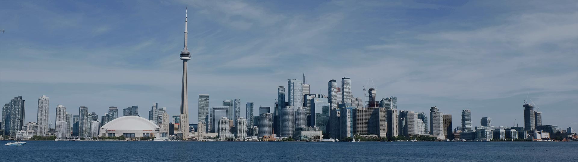 a city skyline with tall buildings and a body of water