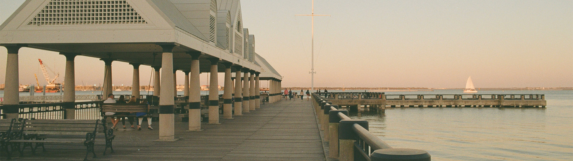 a group of people walking on a dock