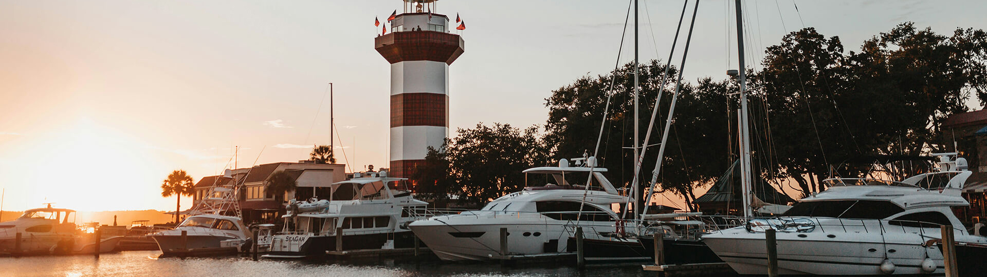 a lighthouse with boats and a lighthouse